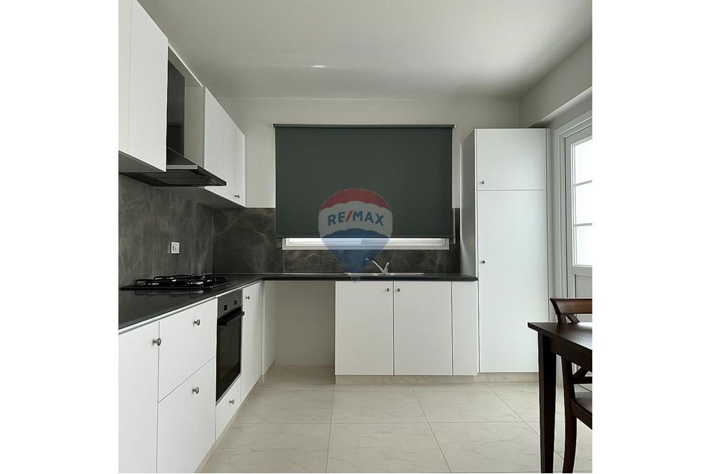Residential - Condo/Apartment - Larnaca Municipality, Larnaca - CY - A_photograph_showcases_a_modern_L-shaped_kitchen_d (1).jpg - 480091017-427